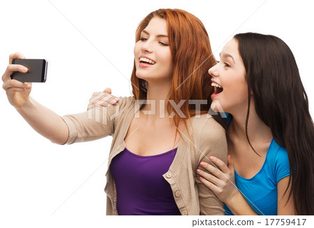 two smiling teenagers with smartphone two smiling teenagers with smartphone 17759417