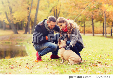smiling couple with dog in autumn park 17759634