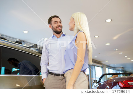happy couple buying car in auto show or salon happy couple buying car in auto show or salon 17759654