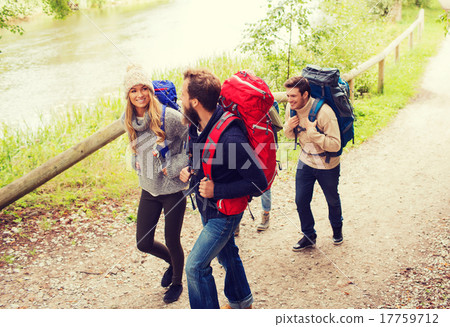 group of smiling friends with backpacks hiking 17759712