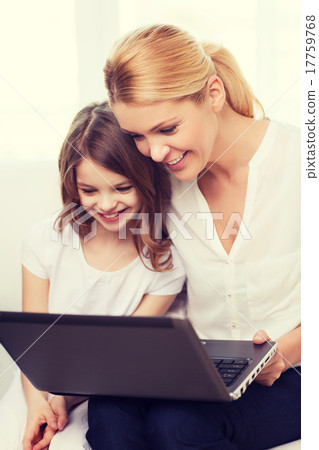 smiling mother and little girl with laptop at home 17759768
