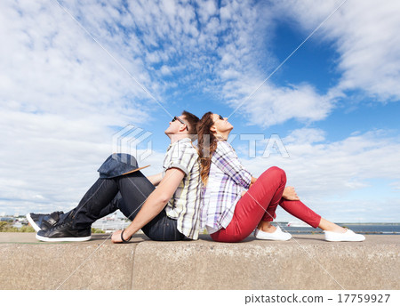 teenagers sitting back to back 17759927