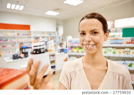 happy female customer with drug jar at pharmacy happy female customer with drug jar at pharmacy 17759930