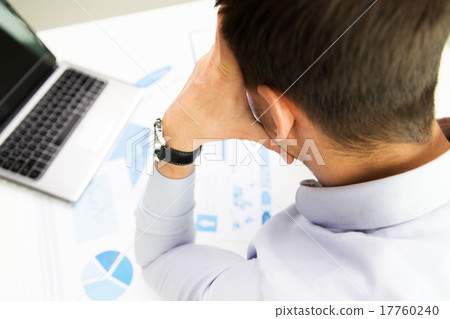 close up of businessman with laptop and papers 17760240
