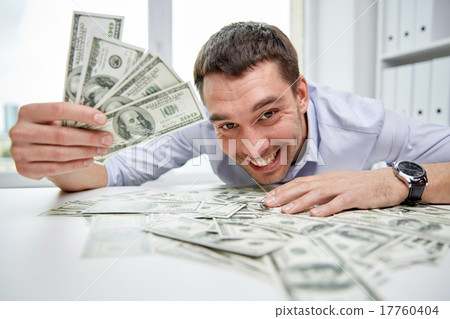 happy businessman with heap of money in office happy businessman with heap of money in office 17760404