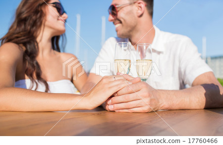 happy just married couple with champagne at cafe 17760466