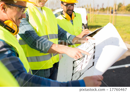 close up of builders with blueprint at building 17760467
