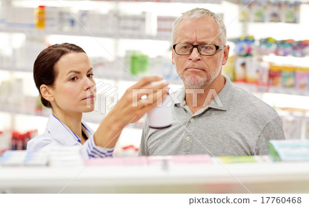 pharmacist showing drug to senior man at pharmacy 17760468