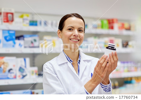 happy female pharmacist with drug jar at pharmacy 17760734