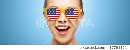 happy teenage girl in glasses with american flag 17761111