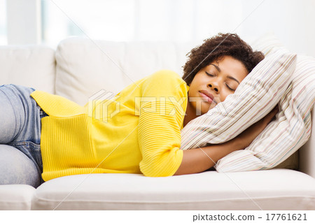 Stock Photo: african young woman sleeping on sofa at home