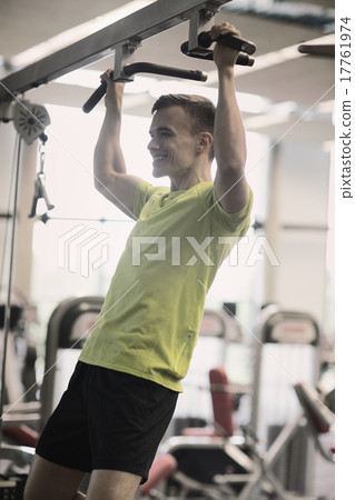 smiling man exercising in gym 17761974