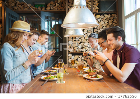 happy friends with smartphones picturing food 17762556