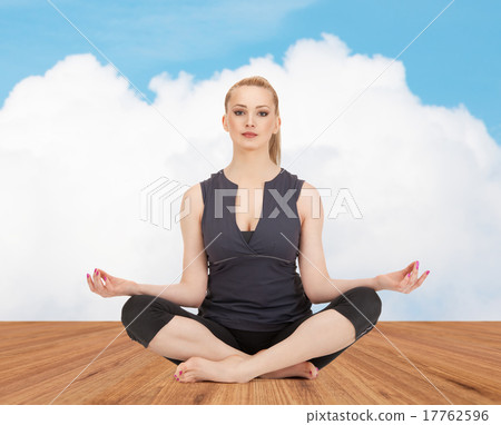 happy young woman meditating in yoga lotus pose 17762596
