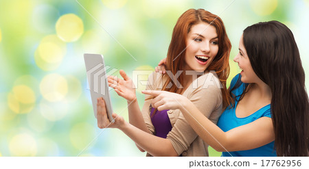 two smiling teenagers with tablet pc computer two smiling teenagers with tablet pc computer 17762956