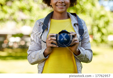 happy african woman with digital camera in park happy african woman with digital camera in park 17762957
