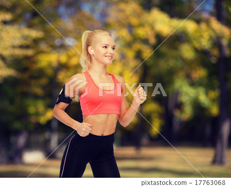 sporty woman running with smartphone and earphones sporty woman running with smartphone and earphones 17763068