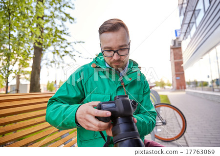 young hipster man with digital camera in city young hipster man with digital camera in city 17763069