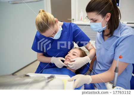 happy female dentist with patient girl at clinic happy female dentist with patient girl at clinic 17763132