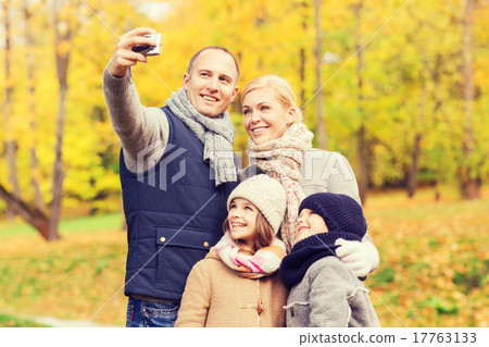 happy family with camera in autumn park happy family with camera in autumn park 17763133