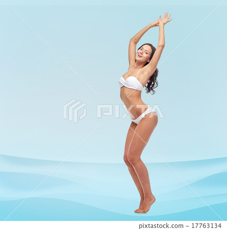 happy young woman in white bikini swimsuit dancing happy young woman in white bikini swimsuit dancing 17763134