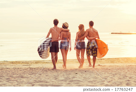 smiling friends in sunglasses with surfs on beach smiling friends in sunglasses with surfs on beach 17763247