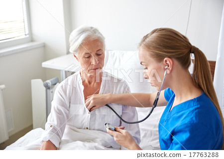 nurse with stethoscope and senior woman at clinic nurse with stethoscope and senior woman at clinic 17763288