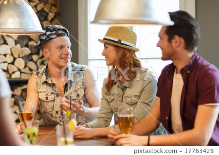 happy friends drinking beer and cocktails at bar 17763428