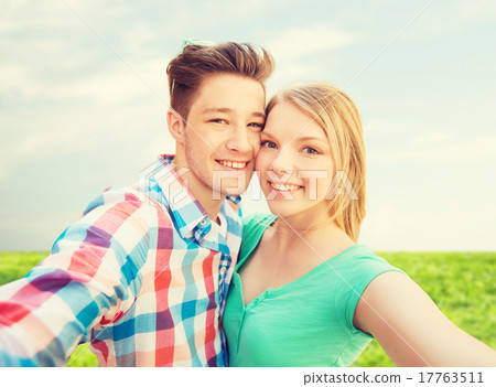 smiling couple with smartphone in suburbs smiling couple with smartphone in suburbs 17763511