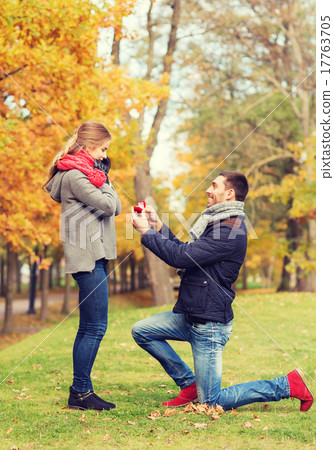 smiling couple with engagement ring in gift box 17763705