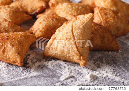 pile of baking samosas on a floured table. pile of baking samosas on a floured table. 17768713