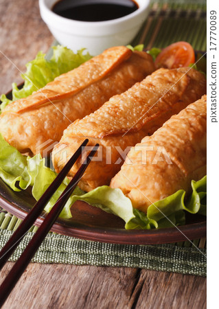 fried spring rolls on a plate and chopsticks  17770089