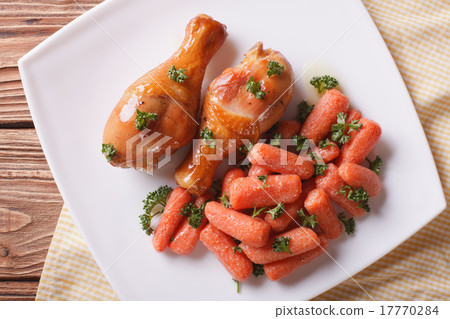 Roasted chicken legs and glazed carrots top view 17770284