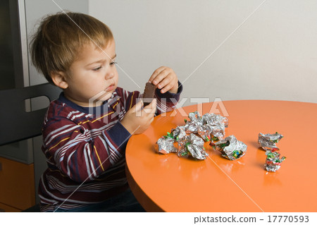 Boy eating chocolates 17770593