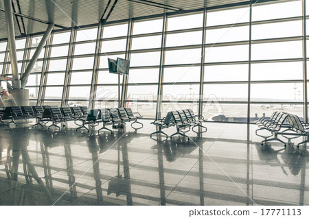 airport waiting area, seats and outside the window airport waiting area, seats and outside the window 17771113