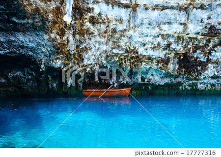 Wooden boat on lake surface. 17777316