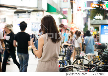 A woman watching a smartphone 17777883