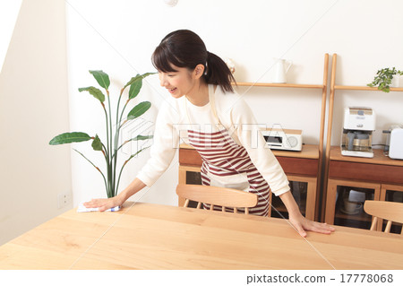 A woman wiping a table A woman wiping a table 17778068