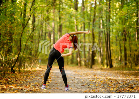 woman exercising in park woman exercising in park 17778371