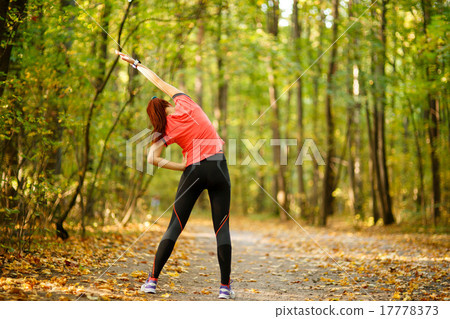 woman exercising in park woman exercising in park 17778373
