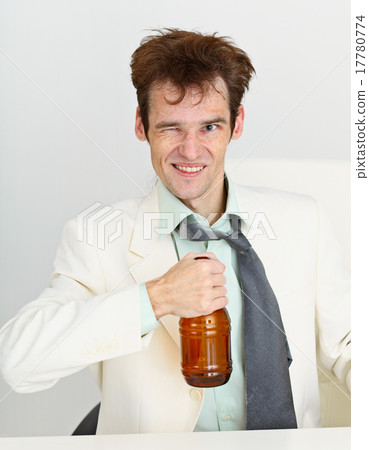 Cheerful guy in a white jacket with bottle of beer Cheerful guy in a white jacket with bottle of beer 17780774