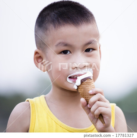 Asian boy enjoying a melting chocolate ice-cream Asian boy enjoying a melting chocolate ice-cream 17781327