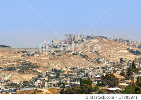 Palestinian village and town separated by wall. 17795971