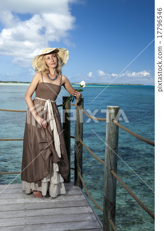 beautiful woman in a long dress on a wooden platfo 17796546