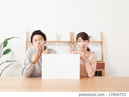 A male and female couple with a troubled face with a whiteboard 17804735