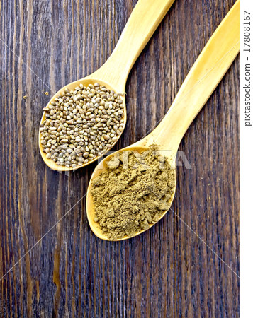 Flour and seed of hemp in spoon on board top 17808167