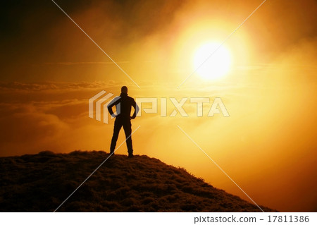 Tall adult hiker in black on the peak of the world Tall adult hiker in black on the peak of the world 17811386