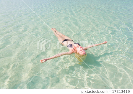Caucasian lady floating in turquoise sea. 17813419