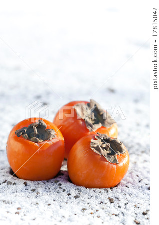 Delicious persimmons on white snow Delicious persimmons on white snow 17815042