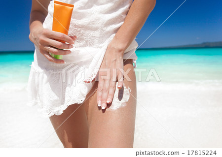 Portrait of woman holding sunscreen cream Portrait of woman holding sunscreen cream 17815224